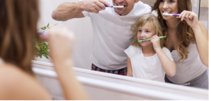 family brushing teeth together