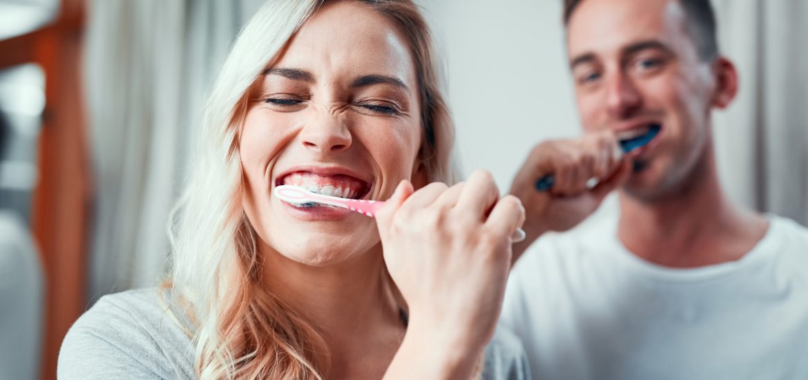 young couple brushing their teeth