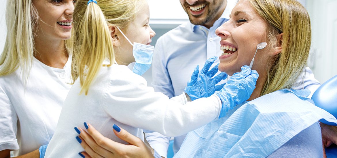 Dentist treating cute blonde child in surgery
