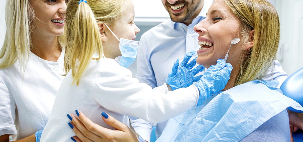 Dentist treating cute blonde child in surgery